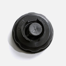Black plastic f1000 Water Tank Cap by Fridja for vertical clothes steamers, shown from above on a white background; features OPEN and CLOSE instructions embossed on the surface.