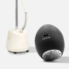 The Fridja Garment Care Duo – f40 and f1200, featuring a clothes steamer and handheld fabric shaver, are displayed on a plain light background, showcasing essential tools for garment care.