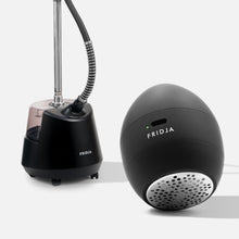 The Fridja Garment Care Duo - f40 and f1200 features a sleek black steamer with water tank and hose in the background, and an egg-shaped fabric shaver in the foreground—perfect essentials for efficient garment care.