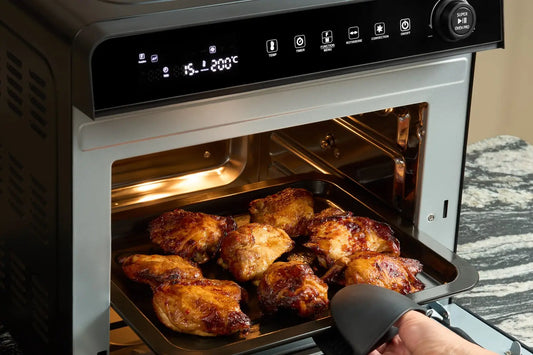Golden chicken thighs on a tray in the Fridja f77 Super Oven Pro air fryer oven