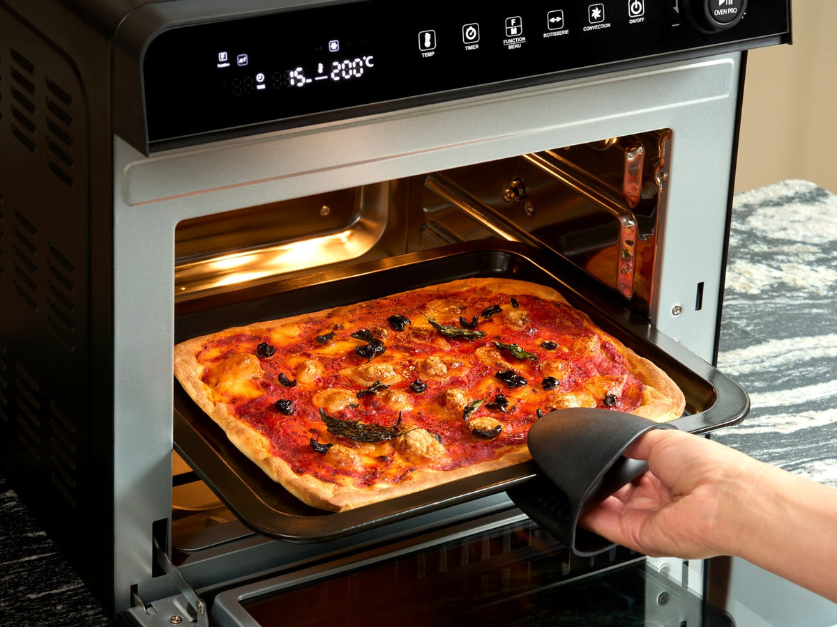 Golden bake being lifted out of the Fridja f77 Super Oven Pro air fryer oven on its baking tray