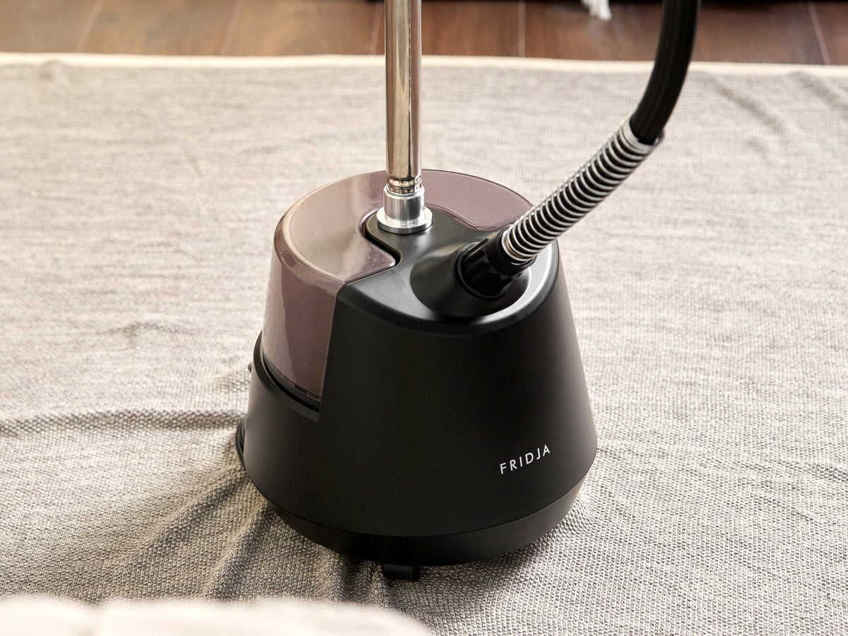 Base and water tank of the Fridja f1200 Clothes Steamer Pro standing on a rug