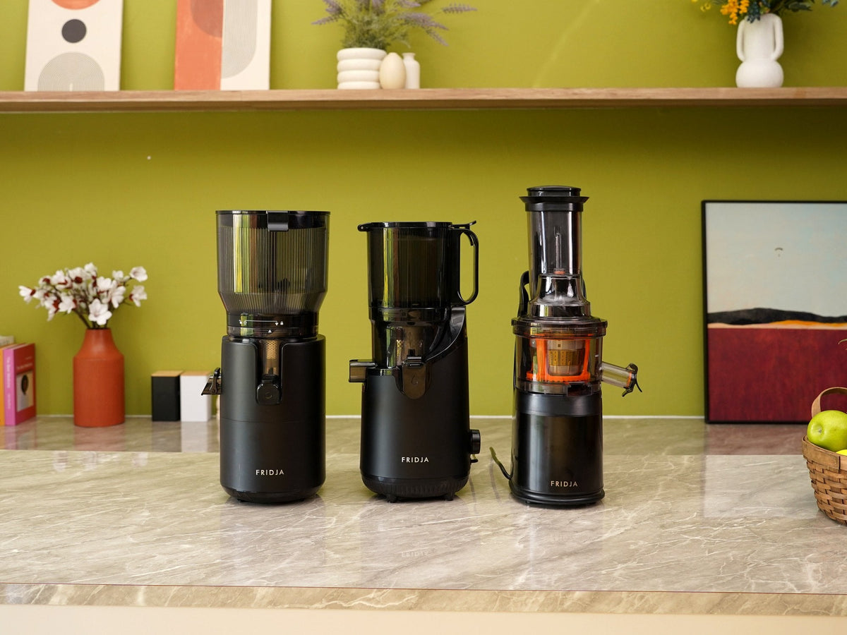 Fridja f2800 Open Whole Fruit Juicer, f2500 Self Feeding Whole Fruit Juicer and f1900 Whole Fruit Juicer side by side on a kitchen worktop
