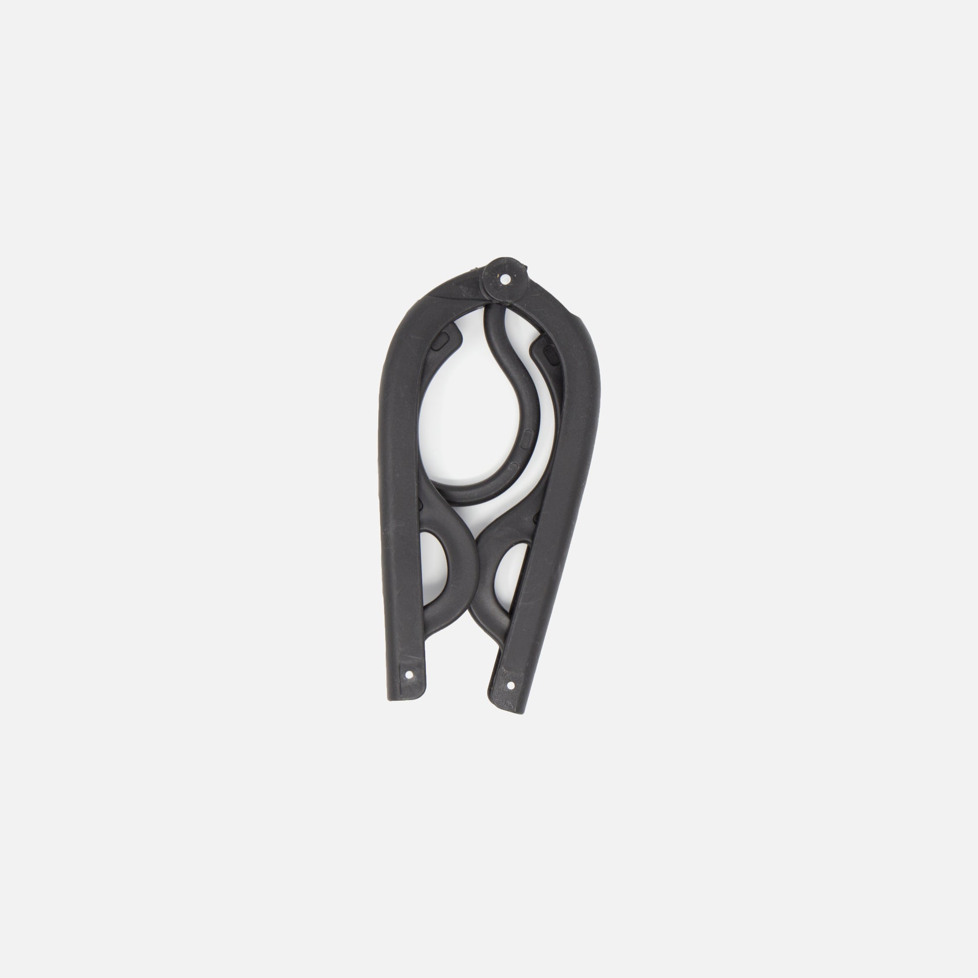 The Fridja f10 Portable Folding Hanger, made from black plastic and metal with curved, scissor-like blades, is shown closed against a plain white background—ideal as a travel garment support or accessory.
