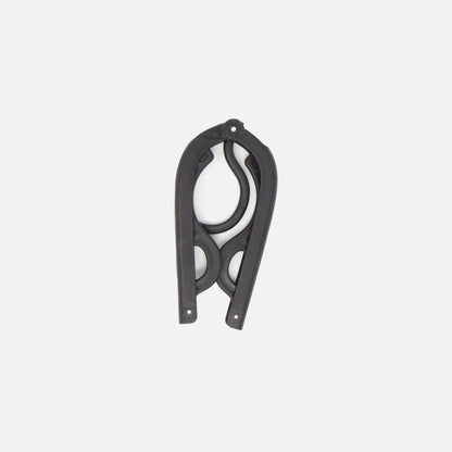 The Fridja f10 Portable Folding Hanger, made from black plastic and metal with curved, scissor-like blades, is shown closed against a plain white background—ideal as a travel garment support or accessory.