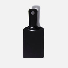 A small, rectangular black plastic Fridja f1500 Cuff Support with a handle and top hole, designed as a high-pressure clothes steamer accessory or for wrinkle removal. Shown on a light gray background.