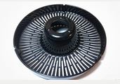 The Fridja f800 Filter Tray is a black, circular plastic reel with precisely spaced slotted grooves, designed for securely holding photographic film during developing.