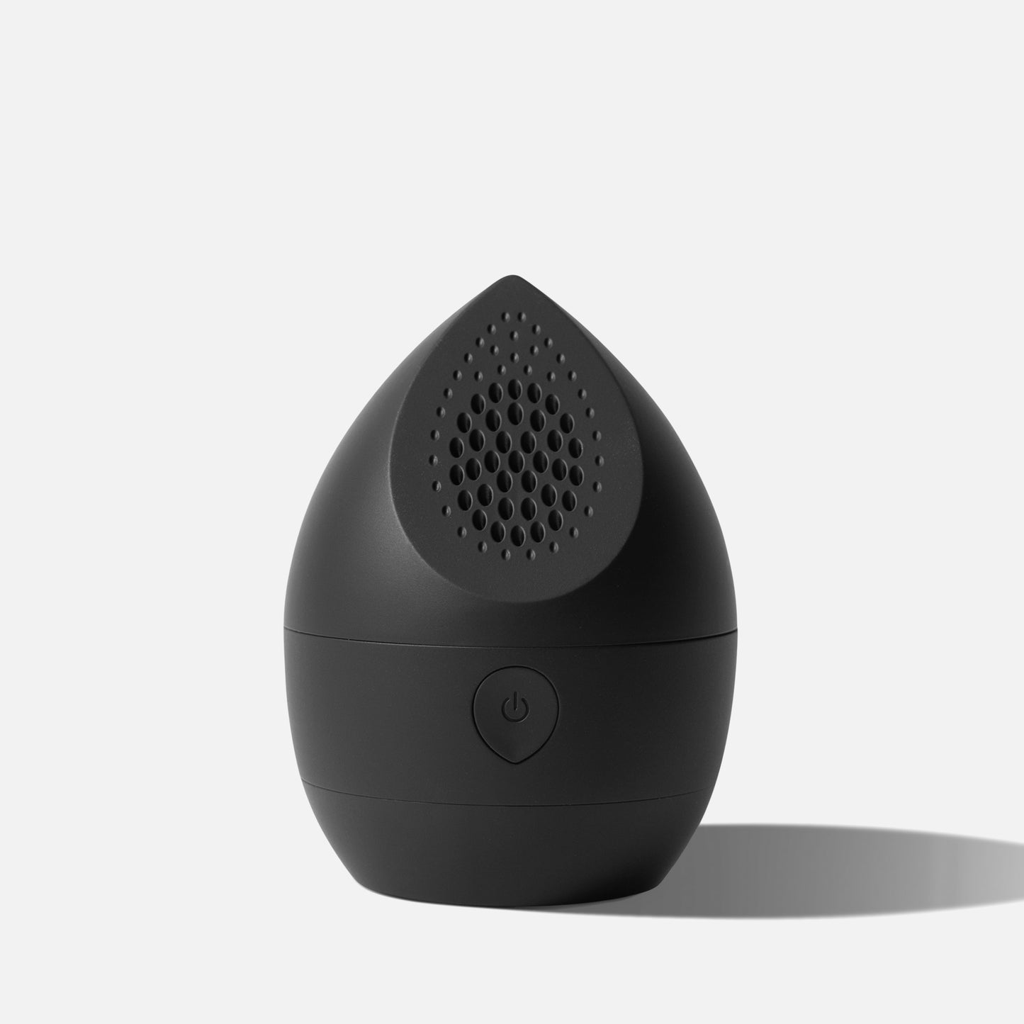 The Fridja f40 Fabric Shaver, a small black teardrop-shaped rechargeable device with a power button on the front and holes at the top, is displayed against a plain white background with a subtle shadow.