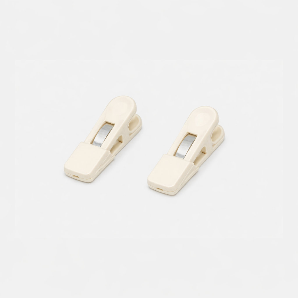 Two beige Fridja f1200 Clips with metal springs are placed side by side on a white background—perfect replacement parts for your f1200 Clothes Steamer Pro.