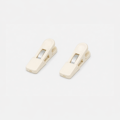 Two beige Fridja f1200 Clips with metal springs are placed side by side on a white background—perfect replacement parts for your f1200 Clothes Steamer Pro.