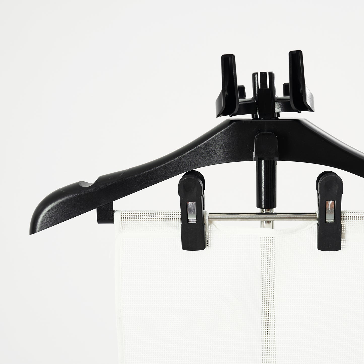 The Fridja Flexible Ironing Board with Clothes Hanger and Pegs securely holds garments, making it perfect for use with commercial clothes steamers to maintain a crisp, professional look against a plain white background.