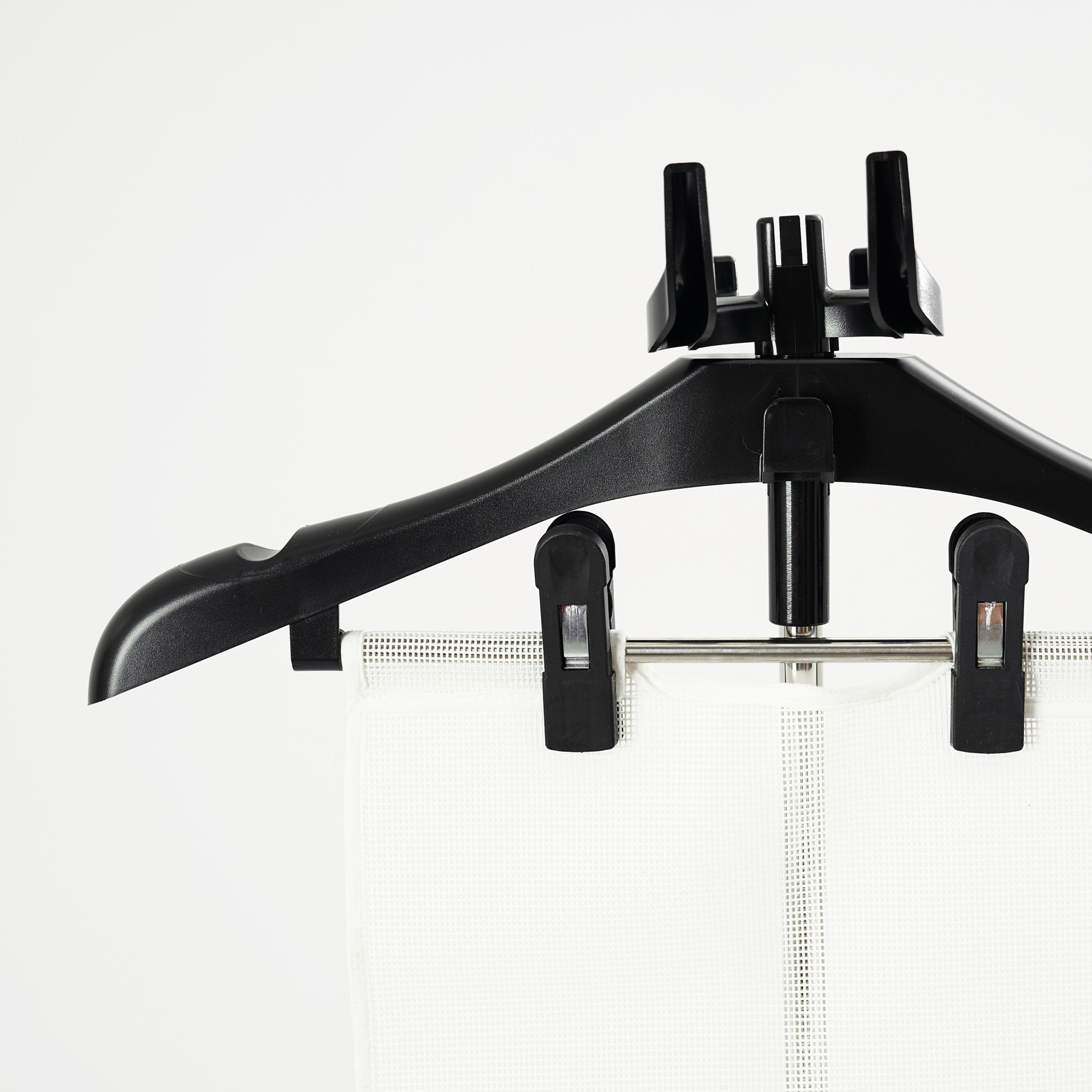 The Fridja Flexible Ironing Board with Clothes Hanger and Pegs securely holds garments, making it perfect for use with commercial clothes steamers to maintain a crisp, professional look against a plain white background.