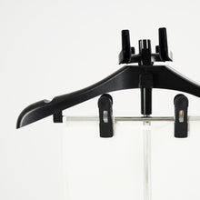 The Fridja Flexible Ironing Board with Clothes Hanger and Pegs securely holds garments, making it perfect for use with commercial clothes steamers to maintain a crisp, professional look against a plain white background.