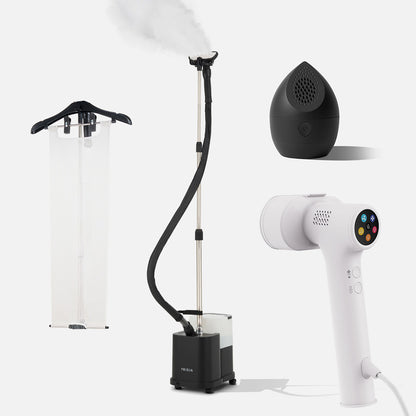 Four household gadgets—the Fridja f1600 Commercial Clothes Steamer with a hanging cover, the sleek black egg-shaped Fridja air purifier, and the white Fridja f20 Handheld Clothes Steamer Pro with digital controls—are all displayed on a white background. They make ideal companions for your laundry routine, especially when paired with essentials like the Fridja Flexible Ironing Board and f40 Fabric Shaver from the Commercial Garment Care Kit.