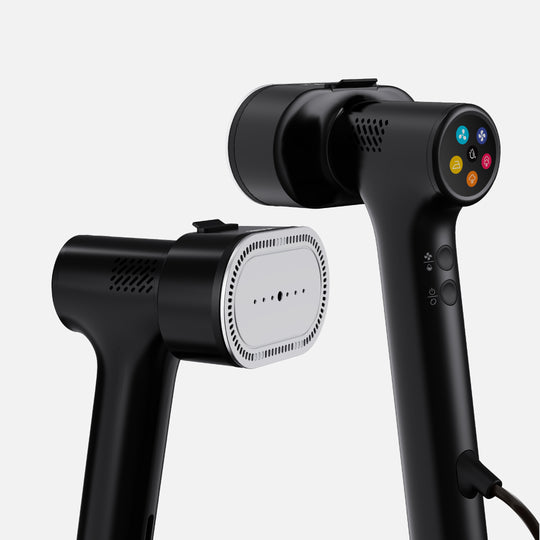 Two Fridja f20 Handheld Clothes Steamer Pros with Suction in black—one positioned to reveal its vented plate, the other highlighting a vibrant button panel and side controls—are displayed against a plain light background, offering a versatile and reliable portable steaming solution.