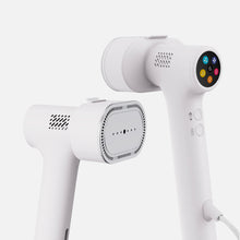Two modern white Fridja f20 Handheld Clothes Steamer Pros are elegantly displayed against a plain white background—one showcases a perforated steam plate, while the other features a circular digital control panel with colorful icons. Perfect for those seeking an efficient portable steam iron or versatile handheld clothes steamer for everyday use.