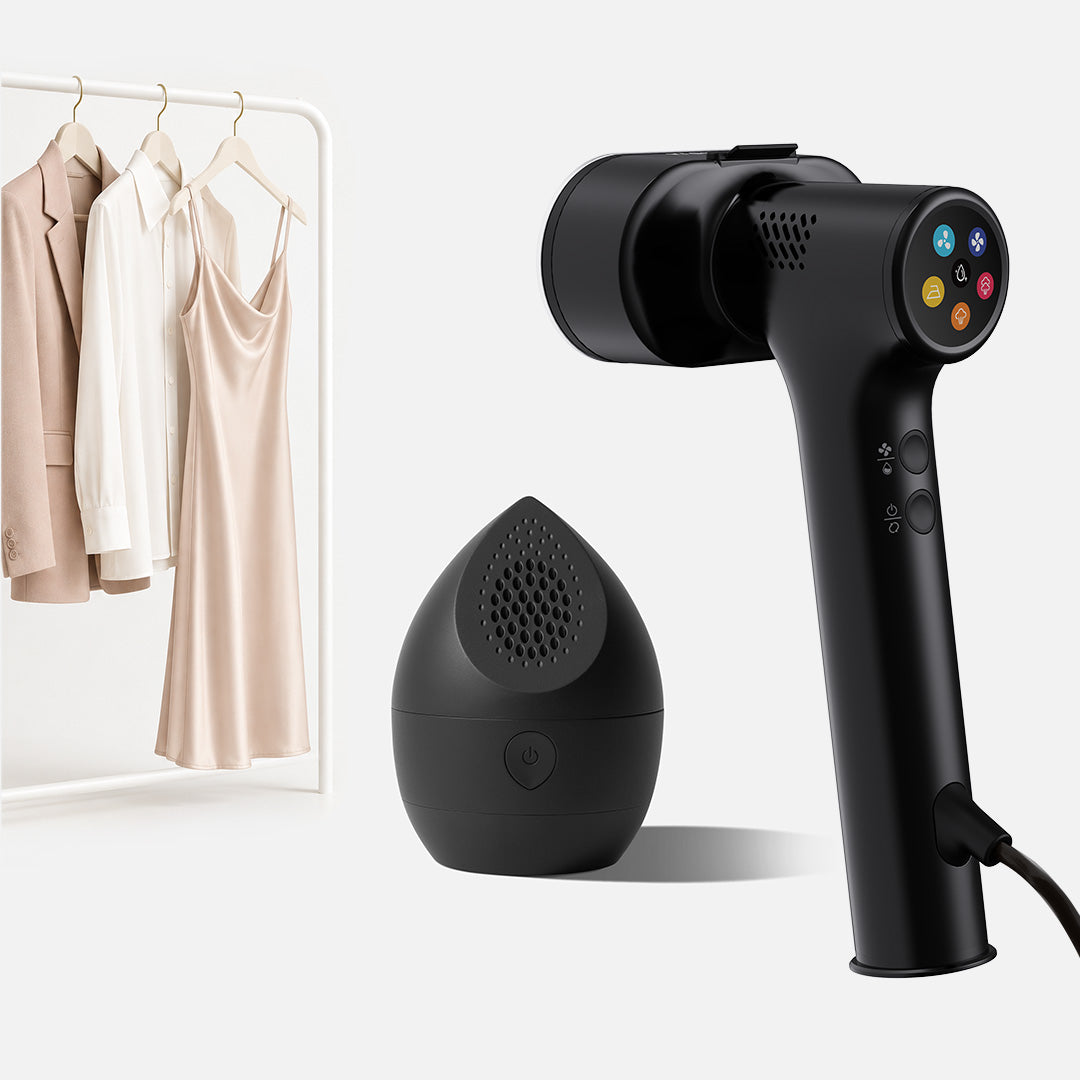 A Fridja Handheld Garment Care Pro Duo – featuring the f20 Handheld Clothes Steamer Pro with Suction and the compact f40 Fabric Shaver – are placed beside a clothing rack adorned with beige garments, showcasing essential Fridja tools for garment care against a clean, light background.