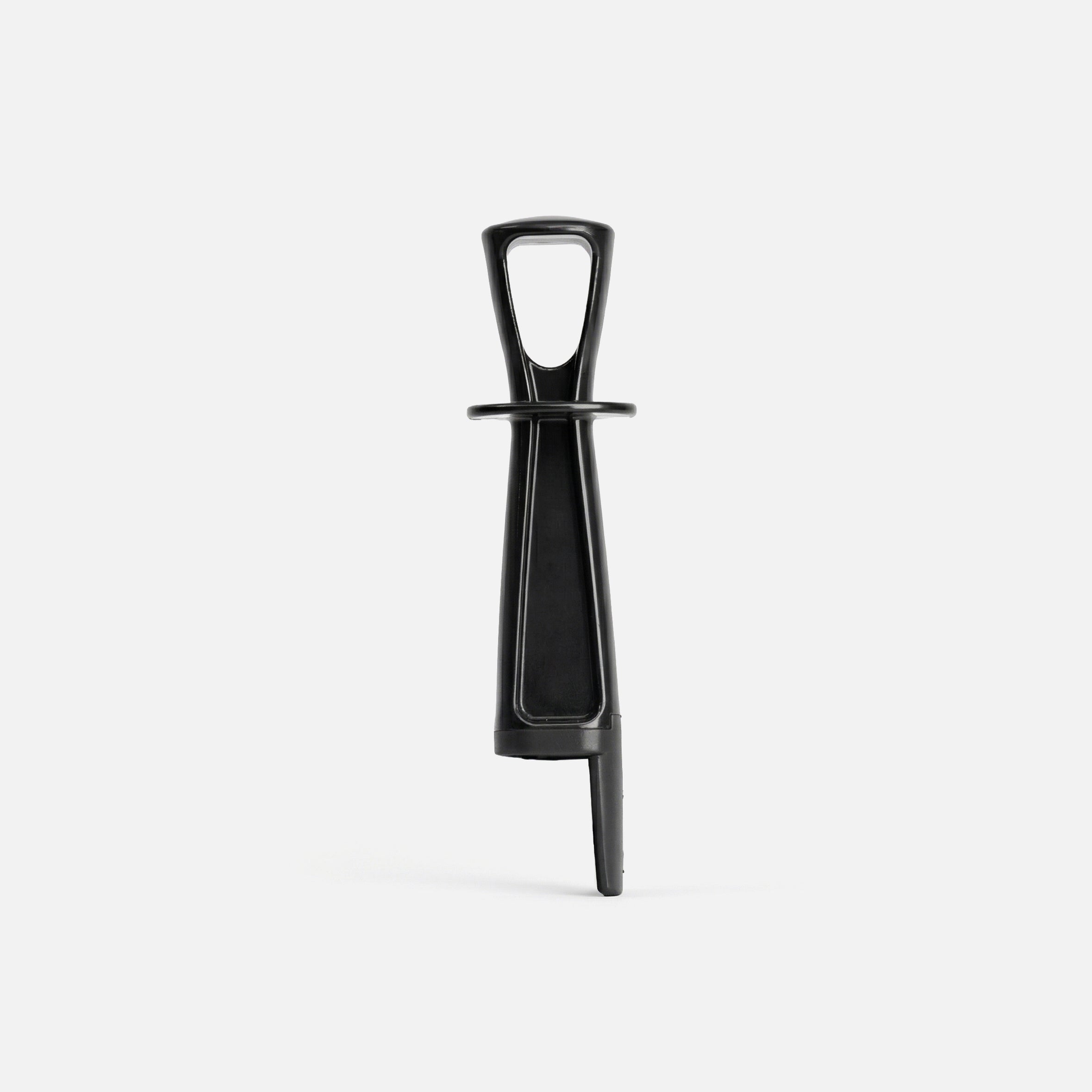 A black plastic wine bottle opener with a T-shaped handle and a vertical body, photographed against a plain white background.