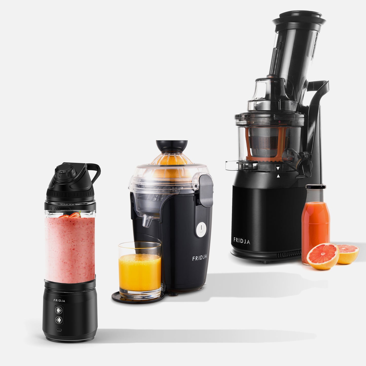 Fridjas Kitchen Trio—f500, f800, and f1900—are shown: a Portable Blender with a pink smoothie, an Automatic Citrus Juicer with orange juice, and a Masticating Juicer with bottles of orange and grapefruit juice beside it.