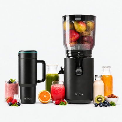 The Fridja Juicer Duo Pro – f2800 Open Whole Fruit Juicer and f600 Stainless Steel Portable Blender, both in sleek black, are showcased with fresh apples, berries, oranges, and nuts inside and around them. Glasses, juice bottles, a matching black travel mug, and an array of fresh fruits complete the light background setting—perfect for making delicious nut milk.