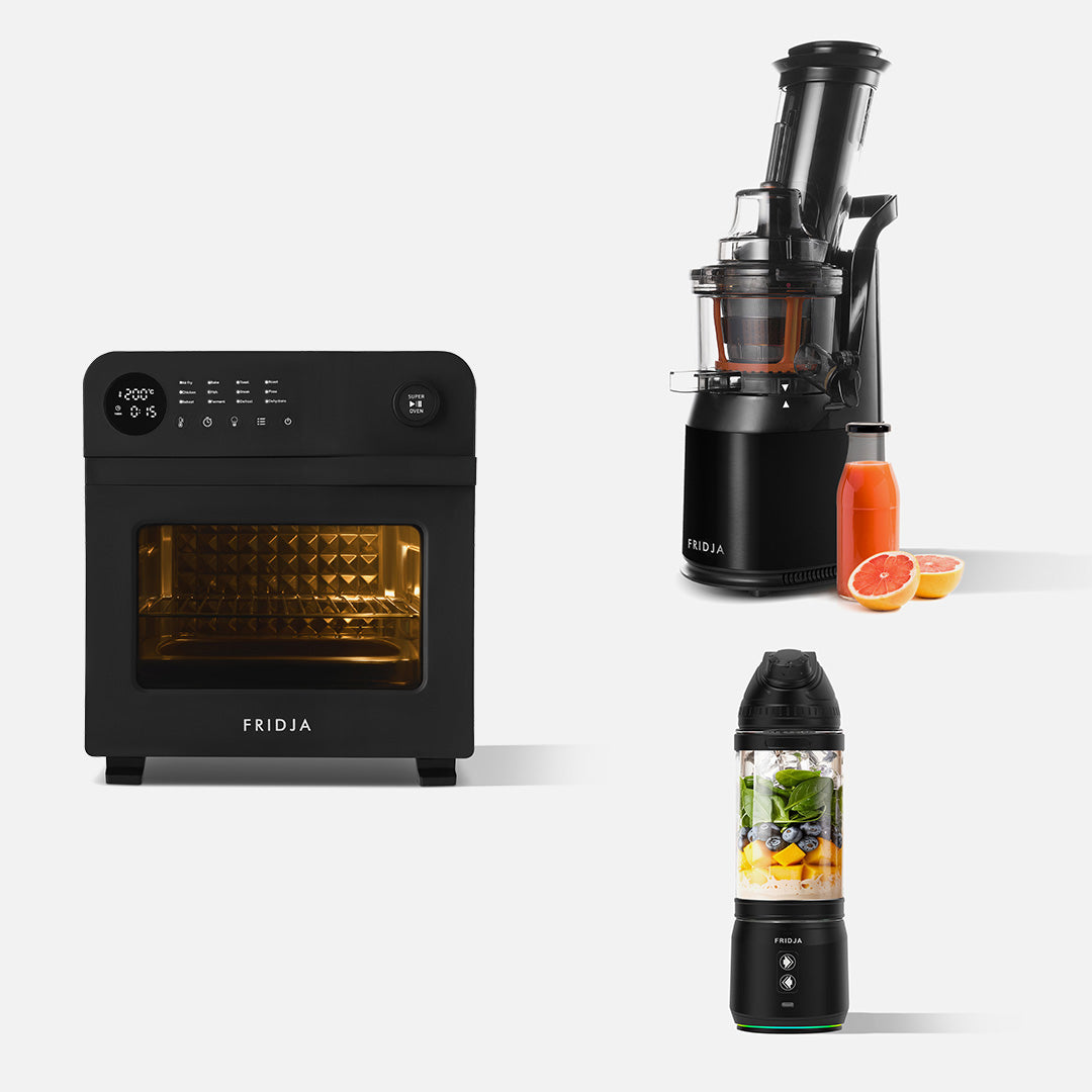 Three compact Fridja kitchen appliances on a white background: the stylish black Kitchen Starter f66 Super Oven air fryer, the f500 Portable Blender filled with leafy greens and fruit, and the f1900 Whole Fruit Juicer with fresh juice and fruits.