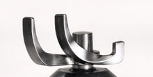 Close-up of a metal blender blade with two curved arms, attached to a black base, against a white background—ideal for use with your Fridja Clothes Steamer Pro or for replacing your Fridja f1200 Head Hanger.